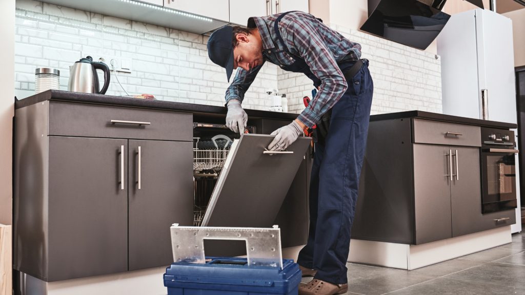 A repair main installing a dishwasher.